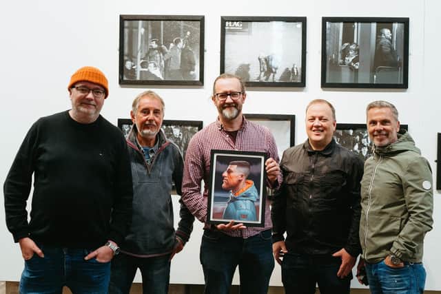 Simon Bartram with his painting and members of Hartlepool's RAW35 photography group.