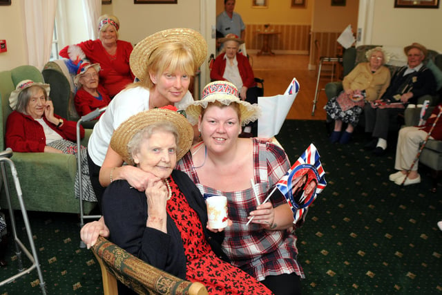 Four Winds Care Home residents celebrate the royal wedding with a tea party. Pictured are staff members Sally Sharples and Alison Thornhill alongside resident Connie Metcalfe, aged 90.