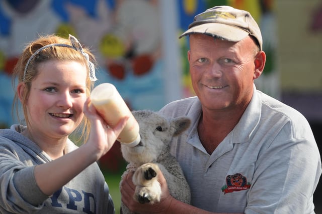 Regan Trundley is pictured feeding one of the lambs at Tweddle Farm in 2012 alongside farm owner Peter Wayman.