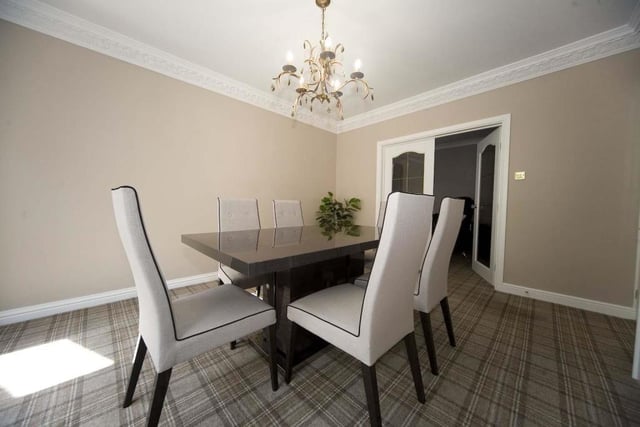 The spacious dining room boasts decorative coving.