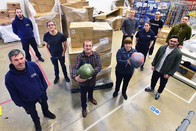 Dan Pearson (front centre) and staff from Ultralight Outdoor Gear with a pallet of sleeping bags that the company has donated to aid the people of Ukraine. Picture by FRANK REID