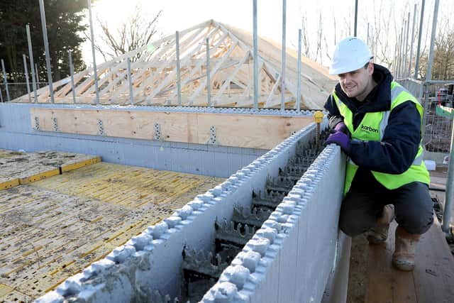Shaun Nixon from Karbon Homes checking on progress, checking an ICF wall after concrete has been poured into the structure of one of the new homes.
