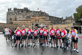 Mark's friends pictured outside Edinburgh Castle at the end of their 200-mile ride.