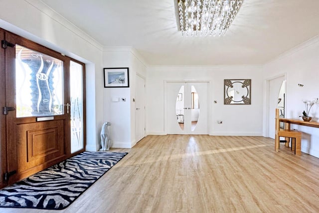 This entrance hall is large and spacious, featuring a cloakroom and guest toilet.