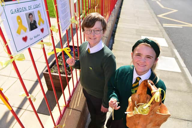 St. Aidan's Primary School pupils James Myers and Eve Gascoigne, both aged 11 fasten yellow ribbons on the school fence in memory their fellow pupil Keisha Watson.