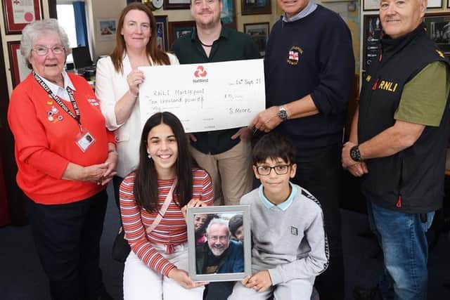 Back row, left to right, Ann Wray, of the Hartlepool RNLI Enterprise Branch, Nicola Parmar, Robert Moore, Hartlepool RNLI chairman Malcolm Cook and Hartlepool RNLI station mechanic Garry Waugh. Pictured at the front holding a photograph of their late granddad are Bethany and Ethan Parmar. Photo: RNLI/Tom Collins
