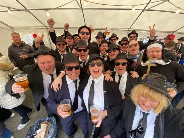 Hartlepool United president Jeff Stelling, second left, joins the Blues Brothers party inside Dorking's ground on the final day of the 2023-24 season.