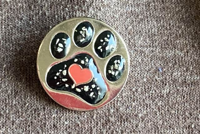 The "Pin Badge" from Roxy's Rainbow Pet Cremation.  by FRANK REID