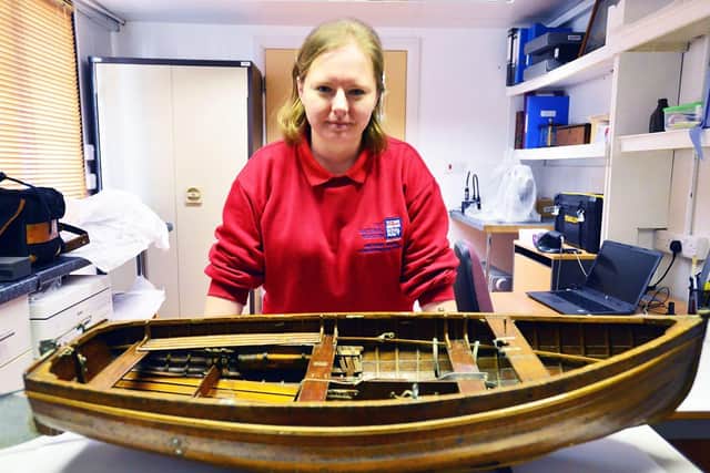 Emma's role also involves maintaining this model ship of a Royal Naval dinghy from the 1960's. Picture by FRANK REID
