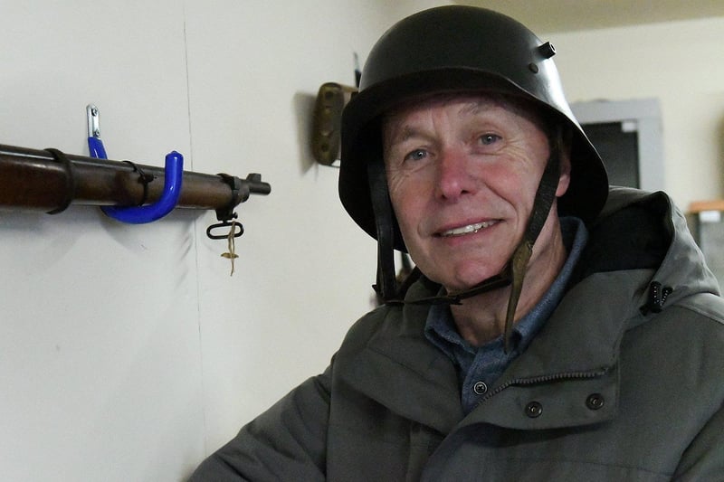 Bill Smith puts on a tin hat during a trip to the Heugh Battery Museum in March.