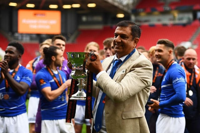 Pools chairman Raj Singh holds aloft the promotion winning trophy at Ashton Gate. (Photo by Harry Trump/Getty Images)