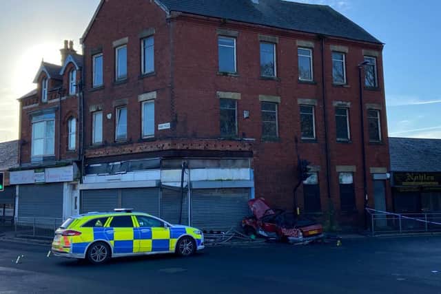 A red Ford Escort was left in the side of a building on the corner of Hart Lane and Raby Road following the collision.
