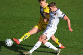 Thomas Peers of Altrincham challenges Reagan Ogle of AFC Fylde during the Emirates FA Cup fourth qualifying round match between AFC Fylde and Altrincham at Mill Farm on October 25, 2020 in Fylde, United Kingdom. (Photo by Alex Livesey/Getty Images)