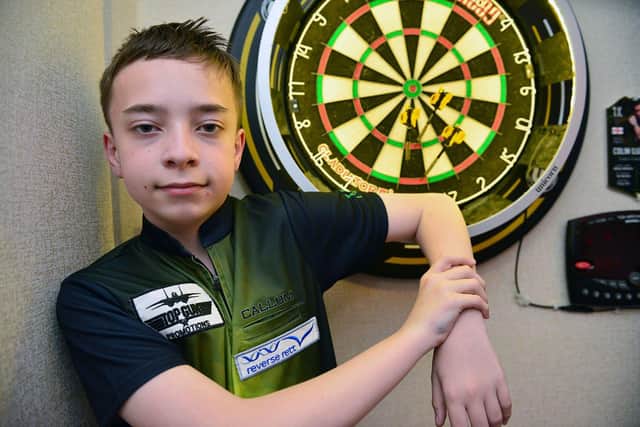 Callum at his dart board at home. Picture by FRANK REID