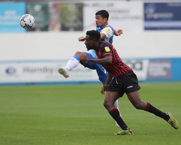 Barrow's Josh Gordon clears under preure from Hartlepool United's Timi Odusina during the Sky Bet League 2 match between Barrow and Hartlepool United at Holker Street, Barrow-in-Furness on Saturday 14th August 2021. (Credit: Mark Fletcher | MI News)
