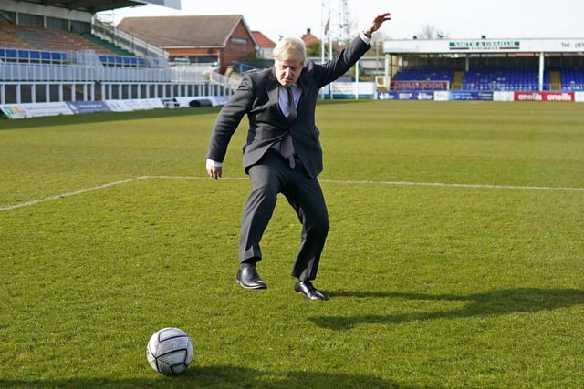 Boris Johnson practices his skills during a visit to Hartlepool United Football Club as he campaigns on behalf of Conservative Party candidate Jill Mortimer ahead of the 2021 Hartlepool by-election. Photo by IAN FORSYTH/POOL/AFP via Getty Images)