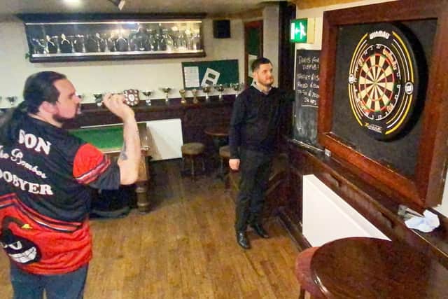 Blacksmiths Arms darts player Jason Boobyer at the board while Steve Banner keeps score.