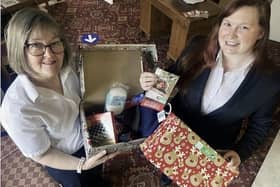 Funeral service arrangers Julia Masshedar and Corina Callan with a shoebox for Operation Christmas Child.