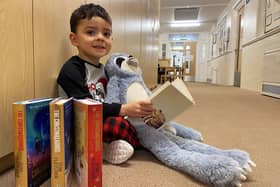 St. Aidan's CE Memorial Primary School pupil Isaac finds a quiet place to read at the end of the Christmas book fair.