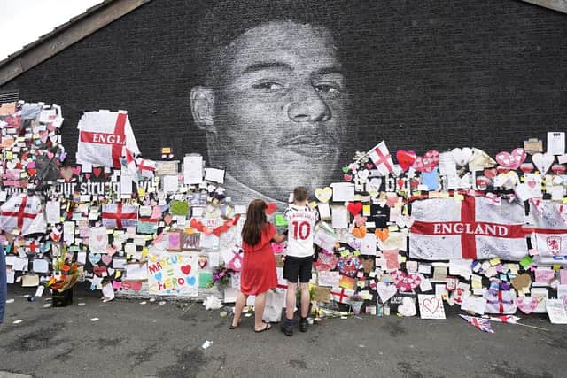 Messages of support and mementos have been left next to a mural of footballer Marcus Rashford after it was vandalised following his penalty miss in England's Euro 2020 final on Sunday.