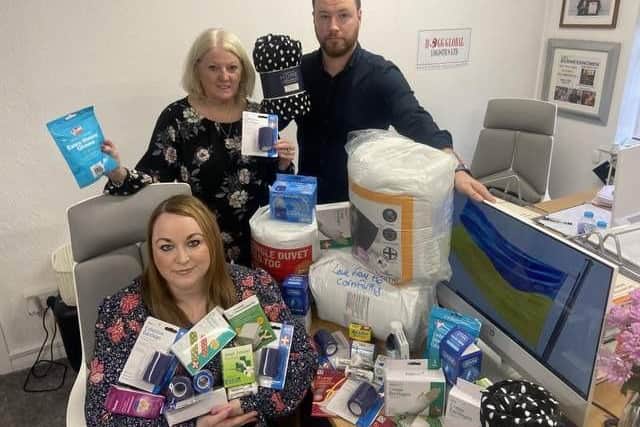 Left to right, Lindsay, Helen and Kevin Hogg, from Hoggs Global Logics, with a selection of donated items back in March of this year.