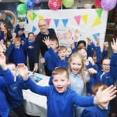 Youngsters help Hartlepool Power Station director Mark Lees celebrate the power station visitor centre's special day.