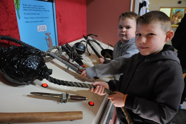 Cody and Xander Griffiths examine some pirate equipment at the Horrible Histories exhibition.