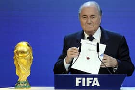 Former FIFA President Sepp Blatter holds up the name of Qatar during the official announcement of the 2022 World Cup host country on December 2, 2010.