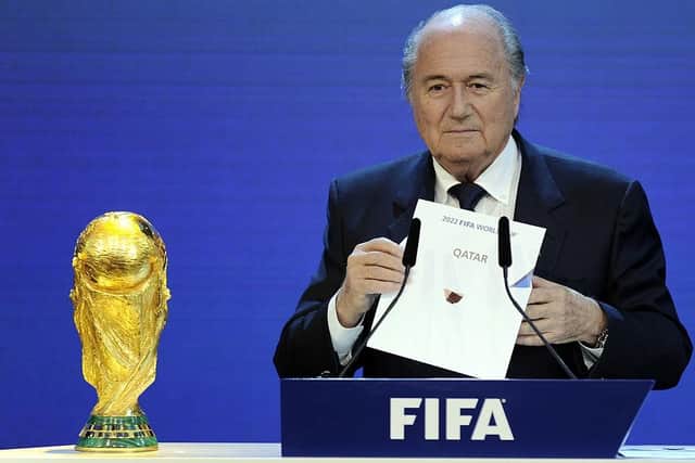 Former FIFA President Sepp Blatter holds up the name of Qatar during the official announcement of the 2022 World Cup host country on December 2, 2010.