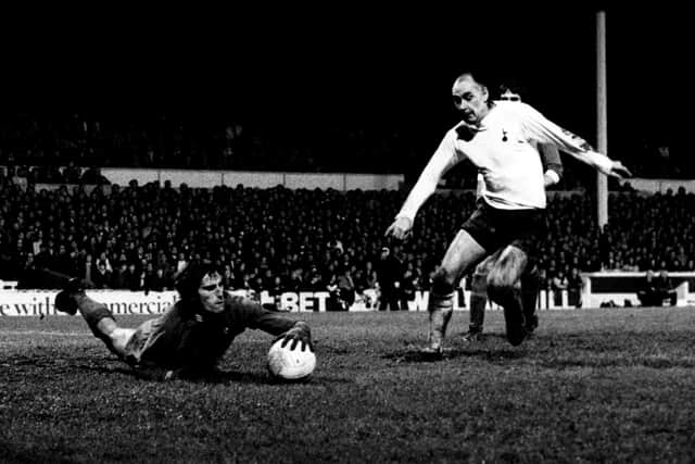 Liverpool goalkeeper Ray Clemence dives at the feet of Tottenham Hotspur's Alan Gilzean.