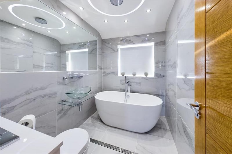 Fully tiled wet room/bathroom with double ended bath and Digital Mira rainfall ceiling shower.