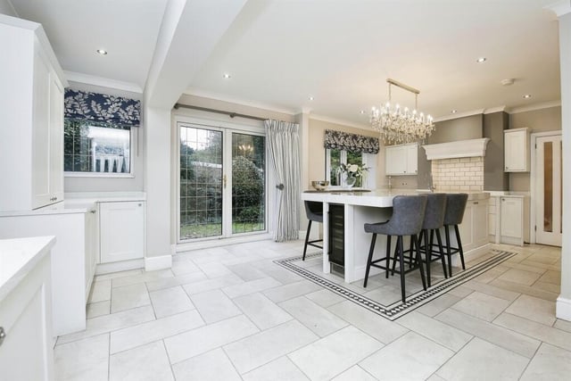 This spacious kitchen area has a central island perfect for cooking and entertaining.