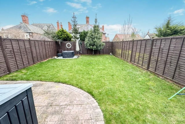 This home has a low maintenance back garden featuring manicured grass and patio areas.