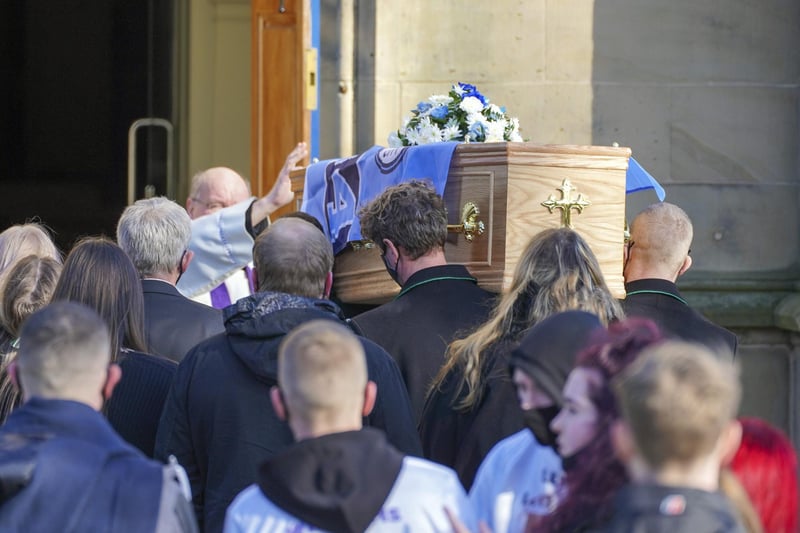 Lewis' casket was adorned with a Manchester City flag as it was carried into church yesterday.