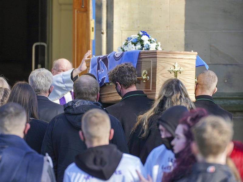 Lewis' casket was adorned with a Manchester City flag as it was carried into church yesterday.