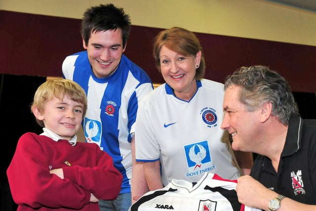 West View Primary School headteacher Andy Brown tempts pupil and Hartlepool United supporter Taylor Robinson into putting on a Darlington shirt, as teachers and fellow Hartlepool United supporters Jonathan Armstrong and Sue Horton look on in 2012.