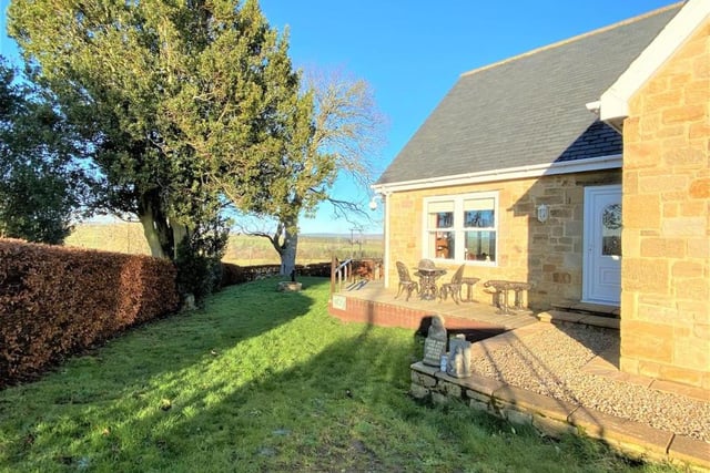 The home has a lovely wrap-around garden and a patio with stunning views over open countryside.