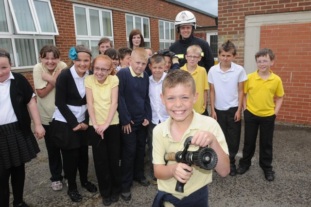Golden Flatts school pupil Kieran Dunning, and classmates, pictured alongside Stuart Simpson and Danielle Hudson of Cleveland Fire Brigade in 2011.