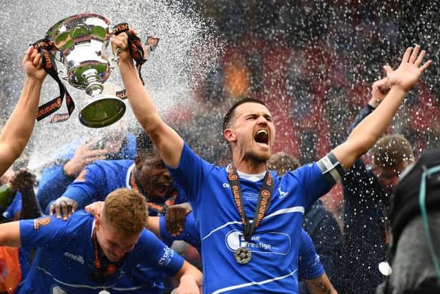 Nicky Featherstone and Ryan Donaldson of Hartlepool United lift the Vanarama National League Trophy during the Vanarama National League Play-Off Final match between Hartlepool United and Torquay United at Ashton Gate on June 20, 2021 in Bristol, England. (Photo by Harry Trump/Getty Images)