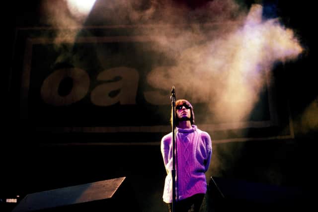 Liam Gallagher performing at Knebworth in 1996. Photo by Roberta Parkin/Redferns.