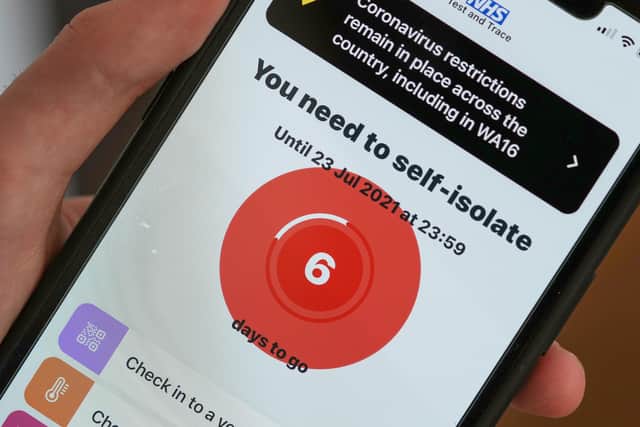 An alert from the NHS Test and Trace app telling people to self islote. Photo illustration by Christopher Furlong/Getty Images.