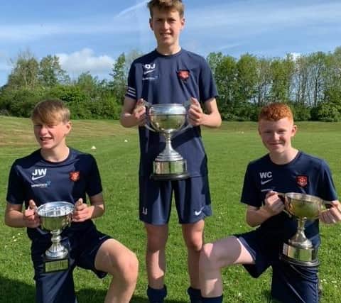 Left to right: Jacob Watson (Year 8), Oscar Jackson (Year 10), and Will Clapham (Year 9) with their Hartlepool Town Cup Finals trophies they won this year.