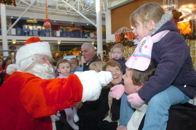 Santa greets the crowds in the shopping centre.