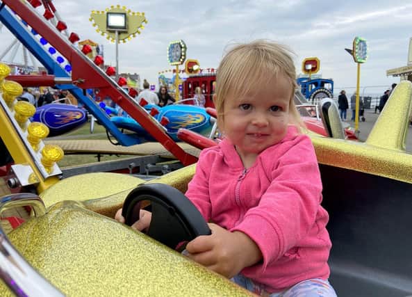 This young driver keeps her hands on the wheel.
