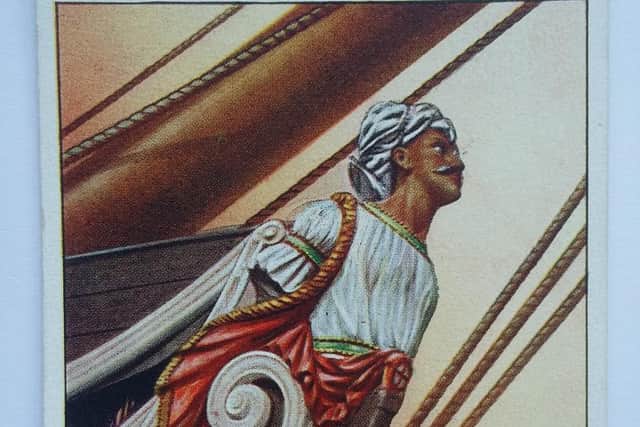 A cigarette card showing the figurehead with red, gold and green colouring used to aid its restoration.