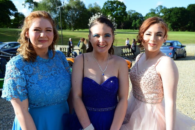 Three friends in their ball gowns.