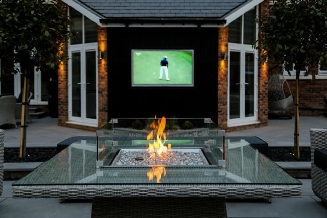 This home has a beautifully landscaped garden featuring a UHD TV screen -to be used as an outdoor cinema - and a fire pit.