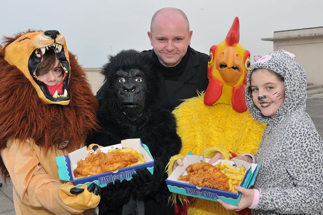 Les Hodgeman from Youngs Fish and Chip shop Seaton Carew serves lunch to Dyke House Sports and Technology College pupils Ben Hall, Daniel Simons, Matthew Lambert and Poppy-Jo Wharton at the end of their fancy dress walk in aid of the RSPCA.