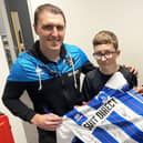 High Tunstall College of Science pupil Reuben Sharpe is presented with an autographed Hartlepool United home shirt by players Callum Cooke (left) and Ellis Taylor. Picture by FRANK REID