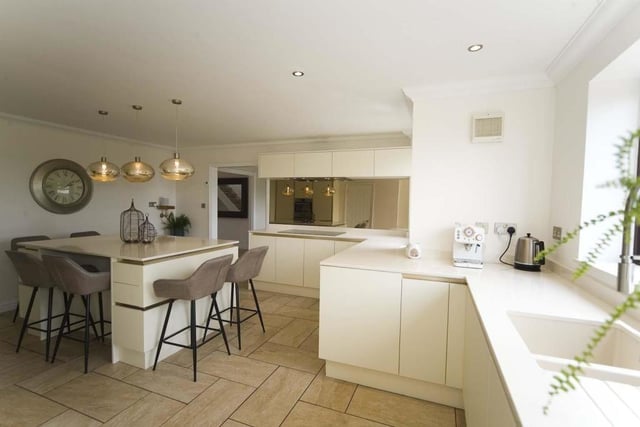 The modern kitchen features a dishwasher, double oven and a microwave among other appliances.